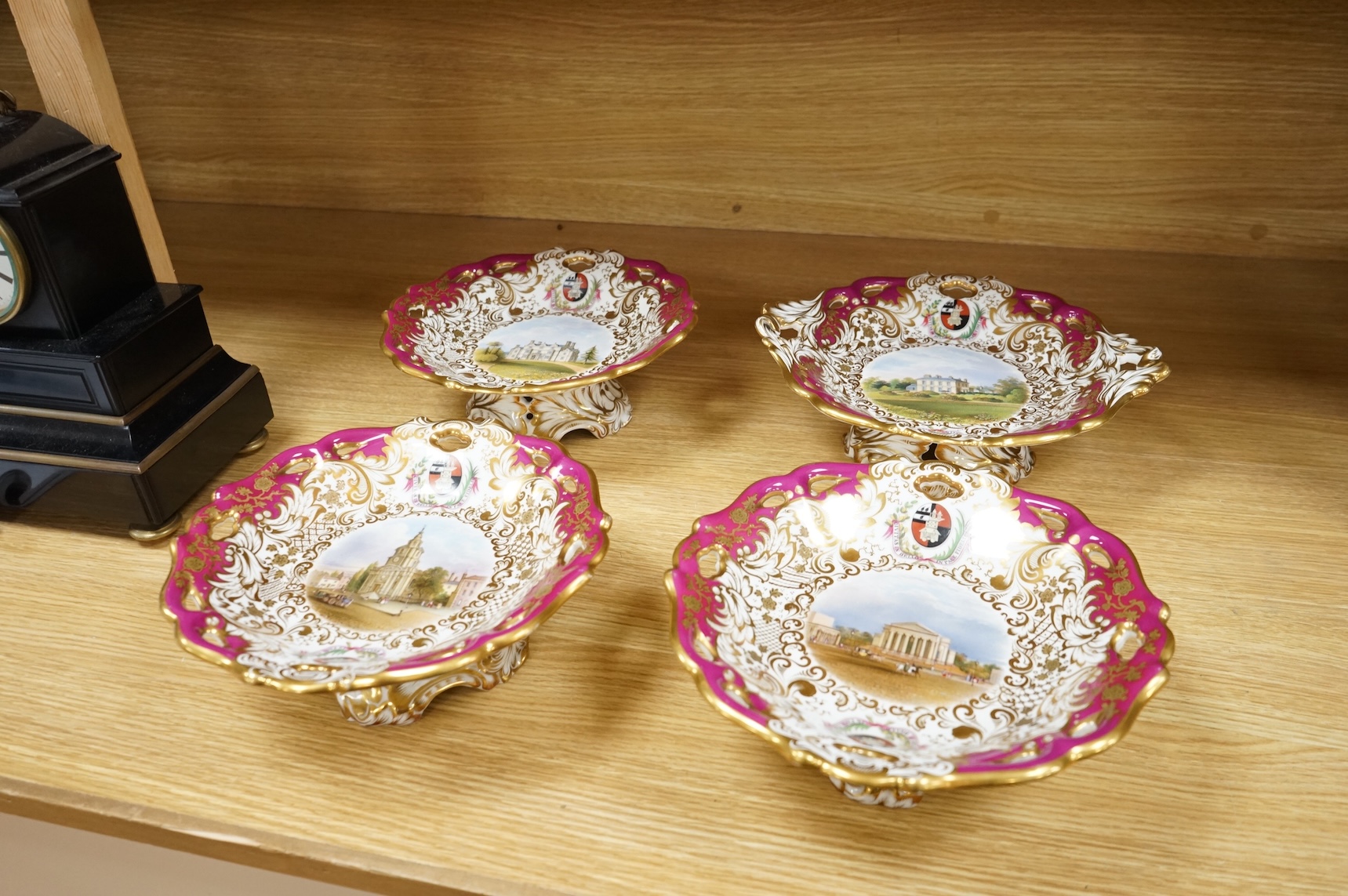 Four G Grainger, Worcester armorial porcelain comports, c.1845, hand painted with named views of Worcester, 24cm in diameter